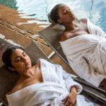 Two ladies laying by the pool side